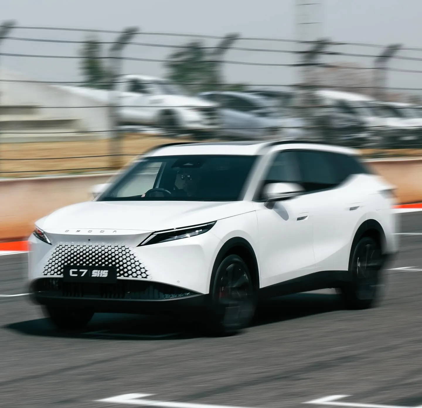 White SUV driving on the racetrack