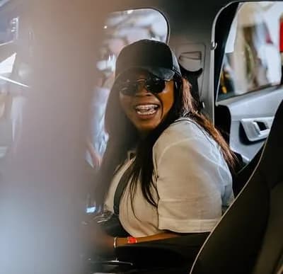 Visitor smiling inside a vehicle